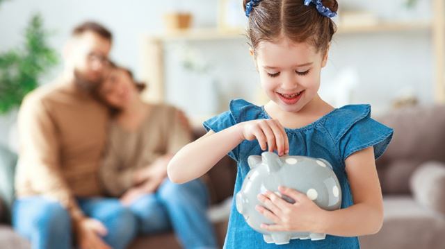 ISAs tax-free savings explained young girl putting money in money box while parents watch